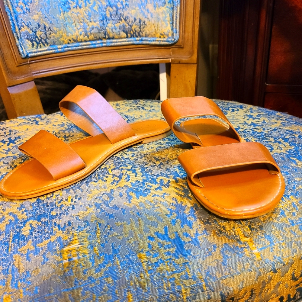Tan flat sandals.